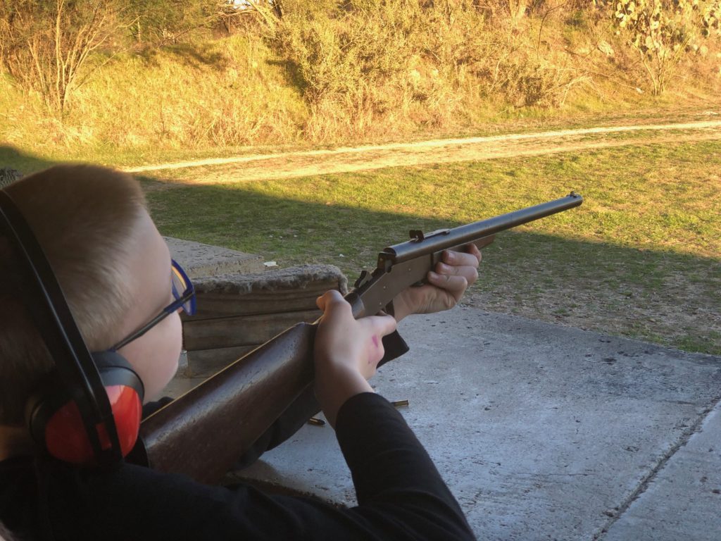 Our younger son aiming his rifle.